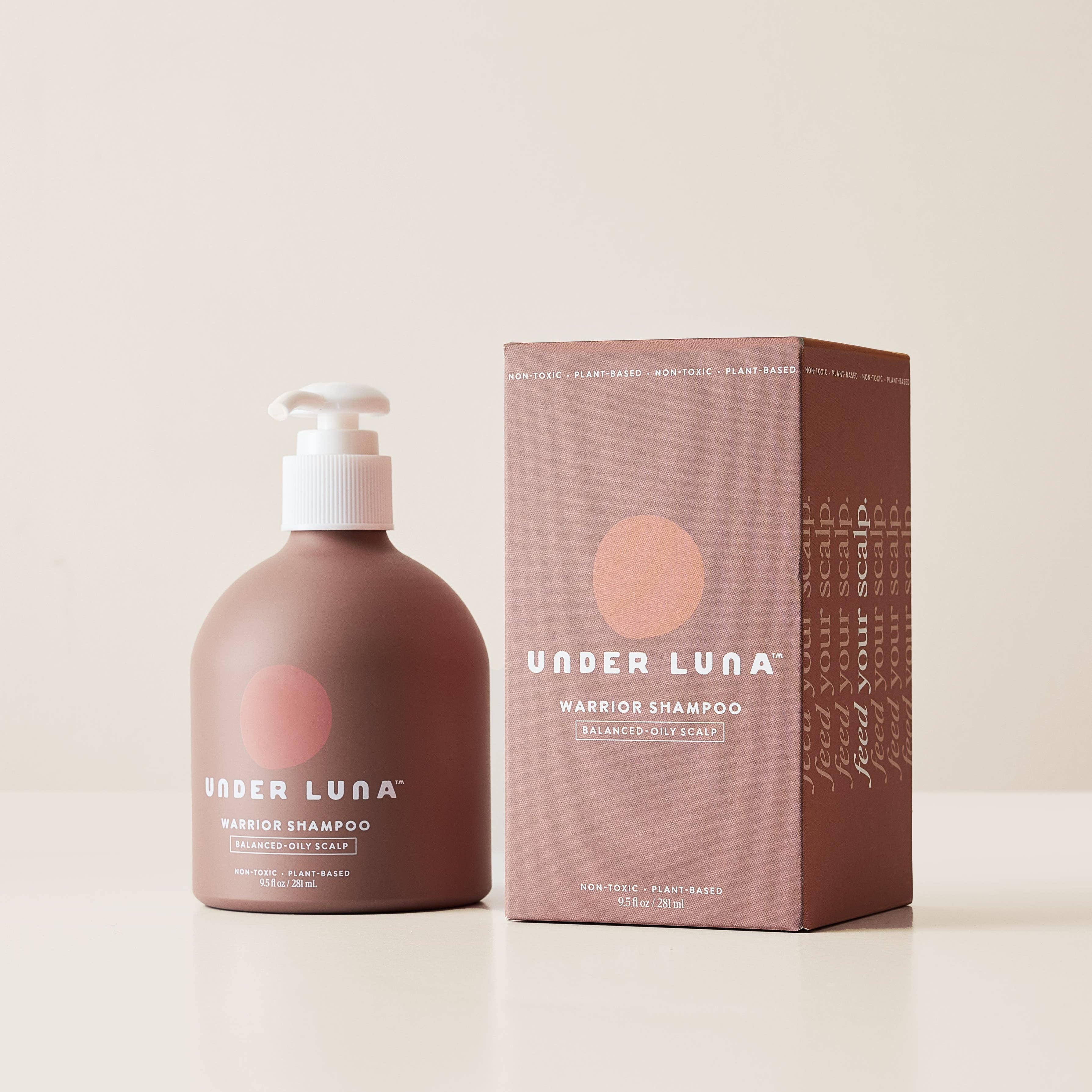Pink shampoo bottle and packaging with 'Under Luna' branding on a beige background